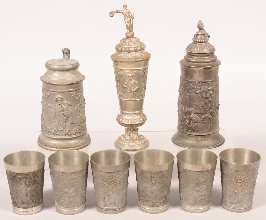 Nine various pieces of vintage pewter with hunter, stag: Nine various pieces of vintage pewter with hunter, stag and game scenes. Stein engraved "LOG CABIN GUN CLUB, NOV. 1913"10-1/4"h. Unmarked shooting trophy with cross bows, guns, targets, etc. 11-3/4"h.