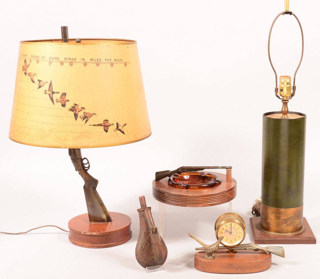 Lot of five decorative hunting related items. Double: Lot of five decorative hunting related items. Double barrel shotgun spelter metal table lamp with shade, 23" high overall, shotgun shell table lamp (no shade) 27-1/2" high overall, wood platform ashtr