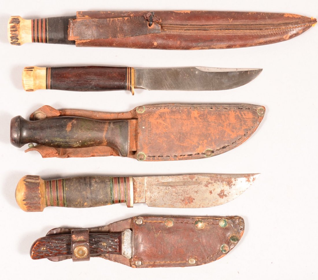 Lot of (5) good hunting knives: 1). Marbles 5" wood: Lot of (5) good hunting knives: 1). Marbles 5" wood handled stag pommel (no scabbard). 2). Marbles 5-3/4" with blood groove, leather washer grip, antler pommel, and tube sheath. 3). Western Cutlery Co