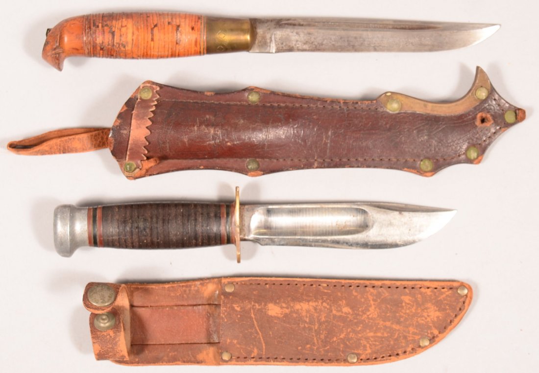 Lot of (2) knives: a Marbles Gladstone having a 5": Lot of (2) knives: a Marbles Gladstone having a 5" blade with wide blood groove and original scabbard plus a Scandinavian hunter's knife with scabbard, birch bark washer handle. Condition: good.
