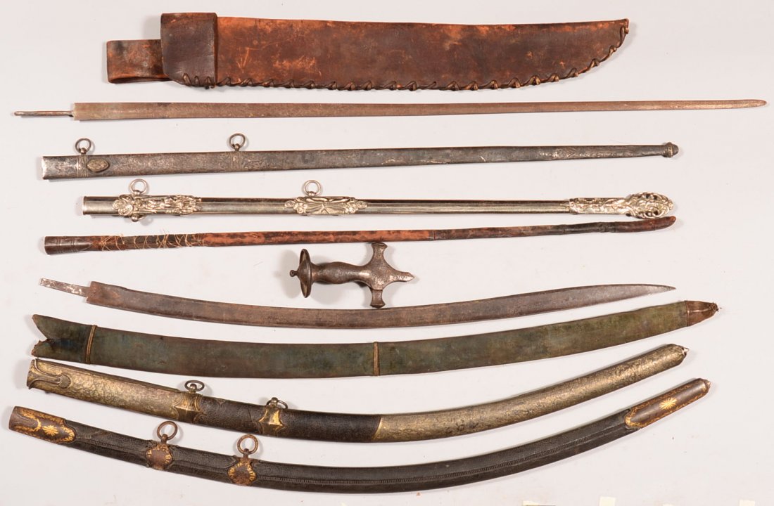 Lot of sword parts incl. (7) scabbards, (2) blades, and: Lot of sword parts incl. (7) scabbards, (2) blades, and an iron Arabian hilt. Condition: fair to good.