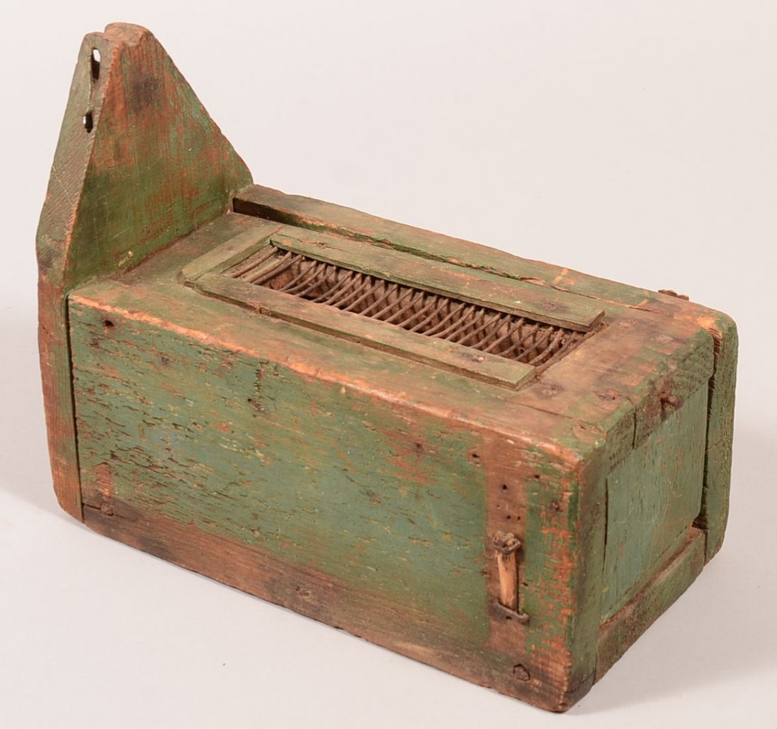 Antique live pigeon trap made of green painted wood: Antique live pigeon trap made of green painted wood having a pivoting lid release. 11-3/4" o/a. Condition: good.