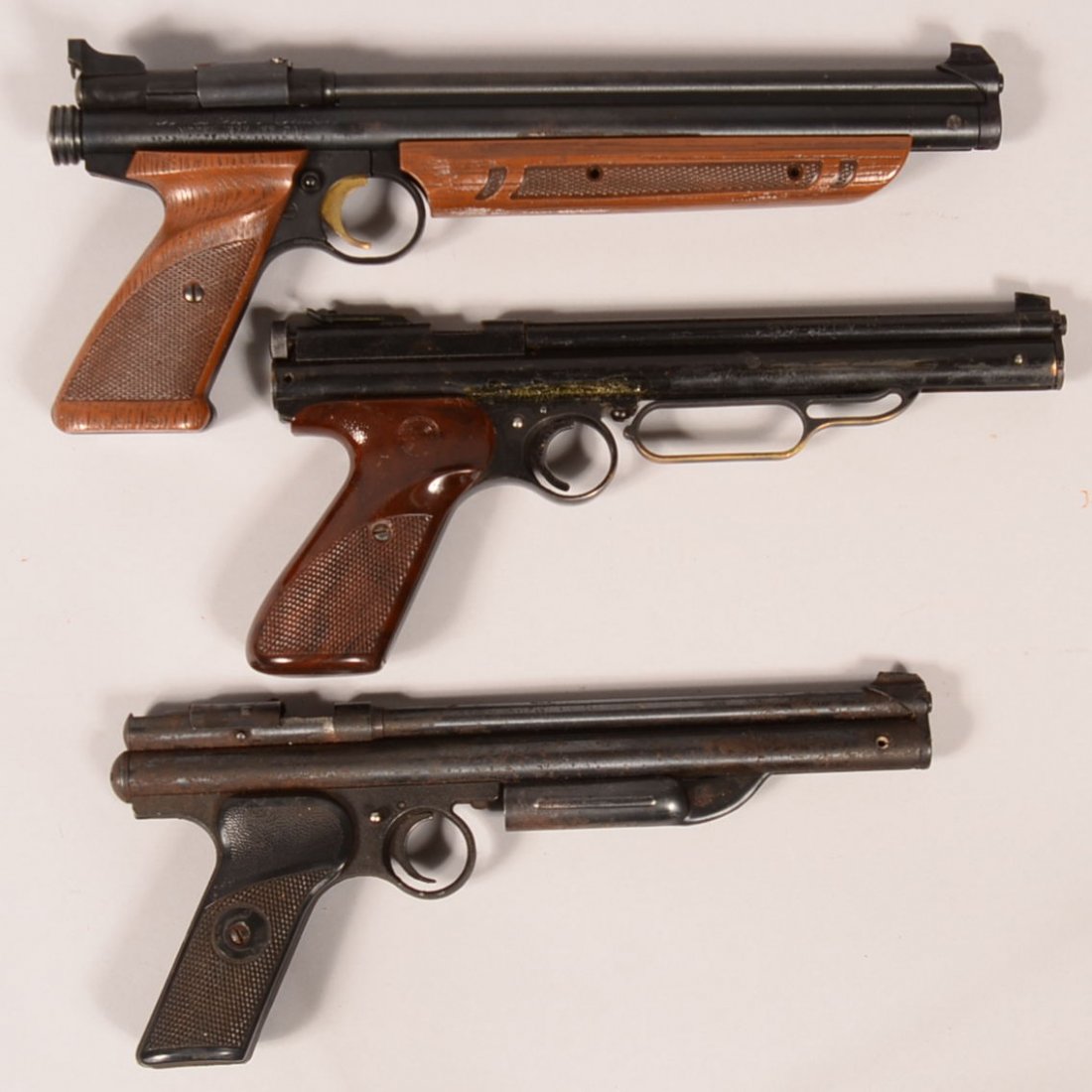 Lot of (3) Crosman pump action air pistols: 1). Model: Lot of (3) Crosman pump action air pistols: 1). Model 130 with a 22 caliber 8-1/2" barrel; 2). Unmarked 22 caliber 8-1/2" lever action with correct leather holster; 3). American Classic model 1377 hav