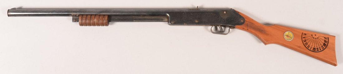 Daisy No. 107 blued Buck Jones Special pump action air: Daisy No. 107 blued Buck Jones Special pump action air rifle having a vine engraved frame and a pistol grip wood stock with impressed sundial and inlet compass. Condition: 90-95% blue, very good stock