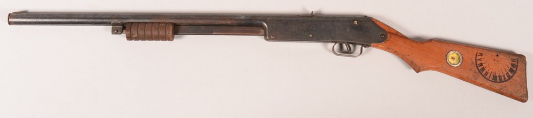 Daisy No. 107 blued Buck Jones Special pump action air: Daisy No. 107 blued Buck Jones Special pump action air rifle having a vine engraved frame and a pistol grip wood stock with impressed sundial and inlet compass. Condition: 70-80% blue with frecking, s