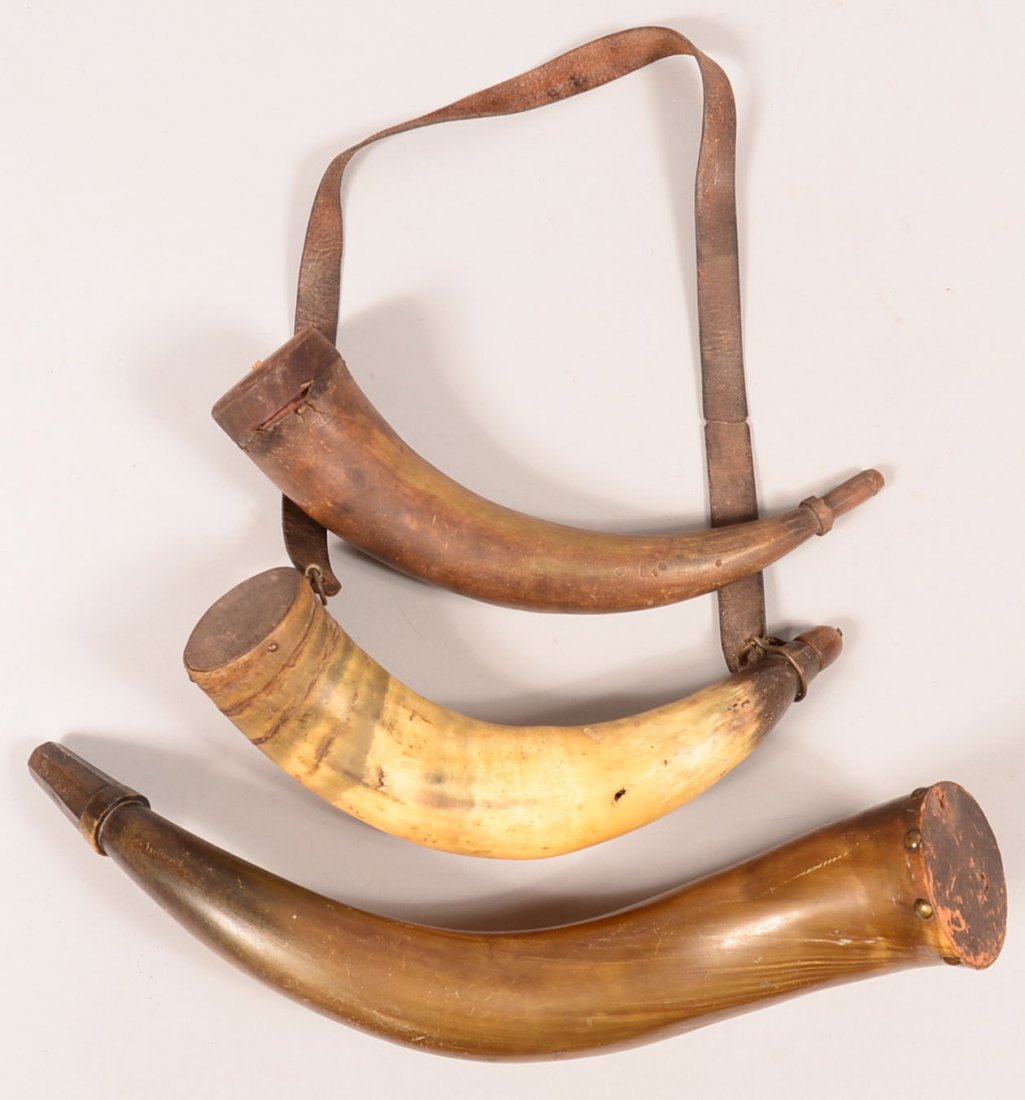 Lot of (3) large powder horns having flat wood bases: Lot of (3) large powder horns having flat wood bases and raised carved spouts. (2) have double curves 15-1/4" to 22" along the outside curve. Condition: good to very good with (1) having some worm hol