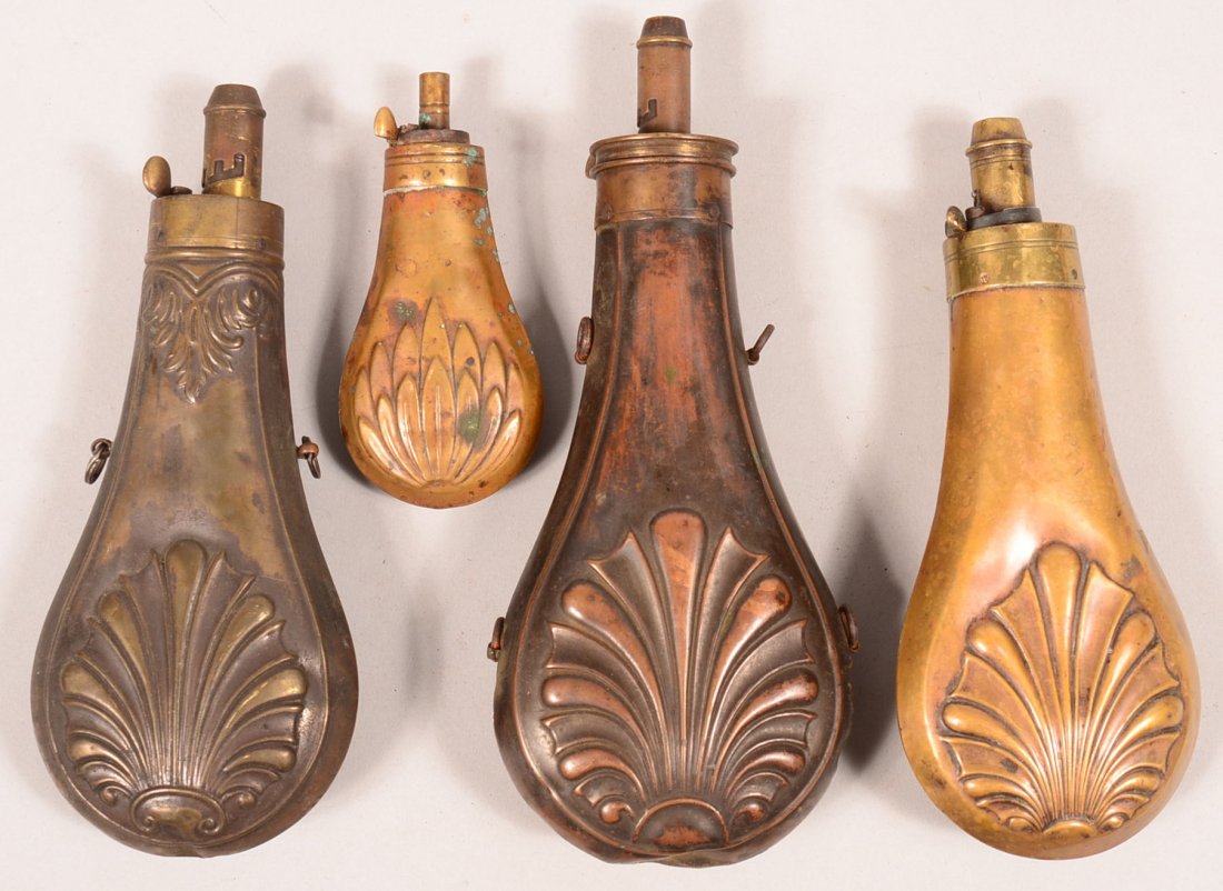 Lot of (4) shell design brass powder flasks 3-5/8" to: Lot of (4) shell design brass powder flasks 3-5/8" to 7-1/4" bodies. Condition: (2) have much of the original finish, some pushes and dents.