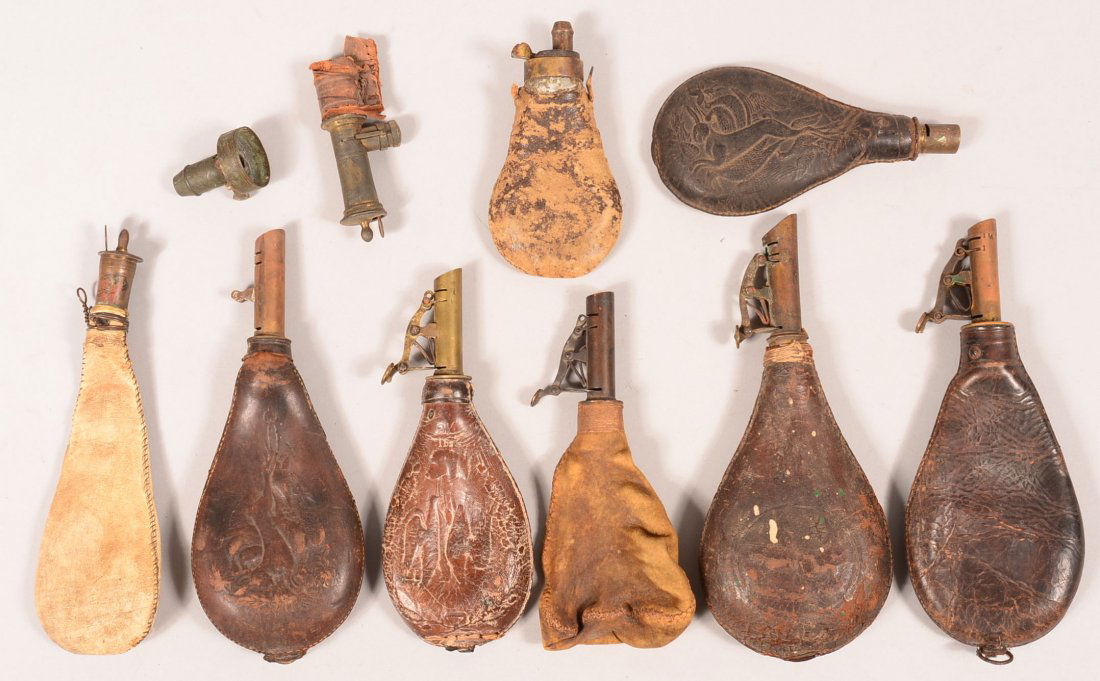 Lot of (8) leather shot pouches having brass chargers,: Lot of (8) leather shot pouches having brass chargers, (1) is buff color leather, (3) with hanging game design. 4-1/4" to 6-1/4" bodies. Condition: poor to good.