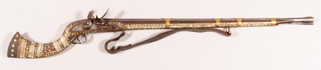 Mother of pearl decorated Sind flintlock musket with a: Mother of pearl decorated Sind flintlock musket with a 37-1/4" octagon to round barrel, (4) brass barrel bands, iron ramrod, leather sling, and an 1810 dated lockworks. The mother of pearl covers most
