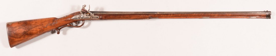 Elaborate raised carved gold decorated silver mounted: Elaborate raised carved gold decorated silver mounted fullstock flintlock smoothbore fowler marked Franz Adam in Feltsperg on the lock and having raised floral scrolls each side of the cheekrest, arou