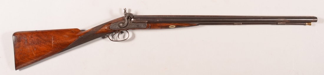 William Read, Boston, double barrel SxS percussion: William Read, Boston, double barrel SxS percussion shotgun having engraved iron mountings, german silver escutcheons, checkered wrist, and 12 gauge 26" barrels. Condition: overall very good to fine an