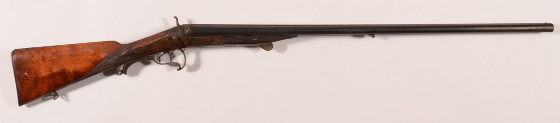 Engraved German under lever double barrel SxS hammer: Engraved German under lever double barrel SxS hammer shotgun having 16 gauge 31-1/2" damascus barrels marked W.A. TANK IN LEIPZIG on the rib. The frame and iron mountings have scroll engraving while t