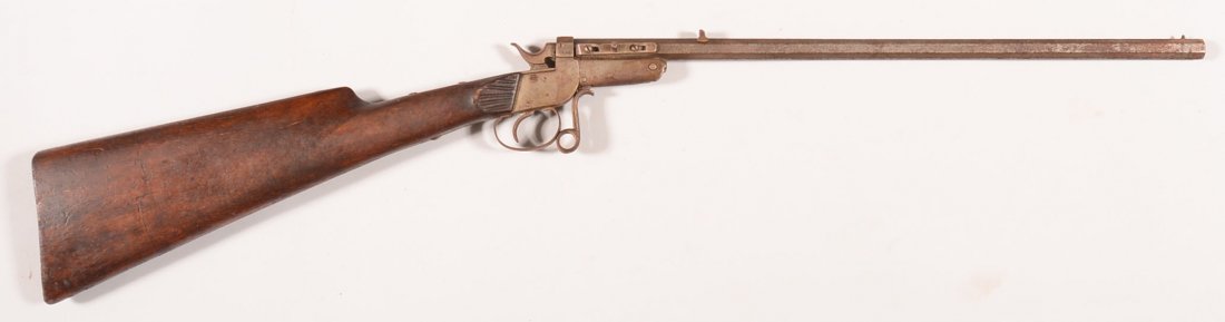 German single shot tip up rifle having a 22 caliber 18": German single shot tip up rifle having a 22 caliber 18" octagon barrel, serial number 18 made without a butt plate or a forearm. Condition: gray patina on metal, sound stock, good working order, needs