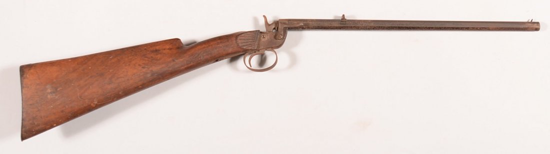 German single shot Flobert action rifle having a 22: German single shot Flobert action rifle having a 22 caliber 15" octagon barrel, serial number 34 having a rollover cheekrest on butt stock and was made without a forearm. Condition: 10-20% blue on bar