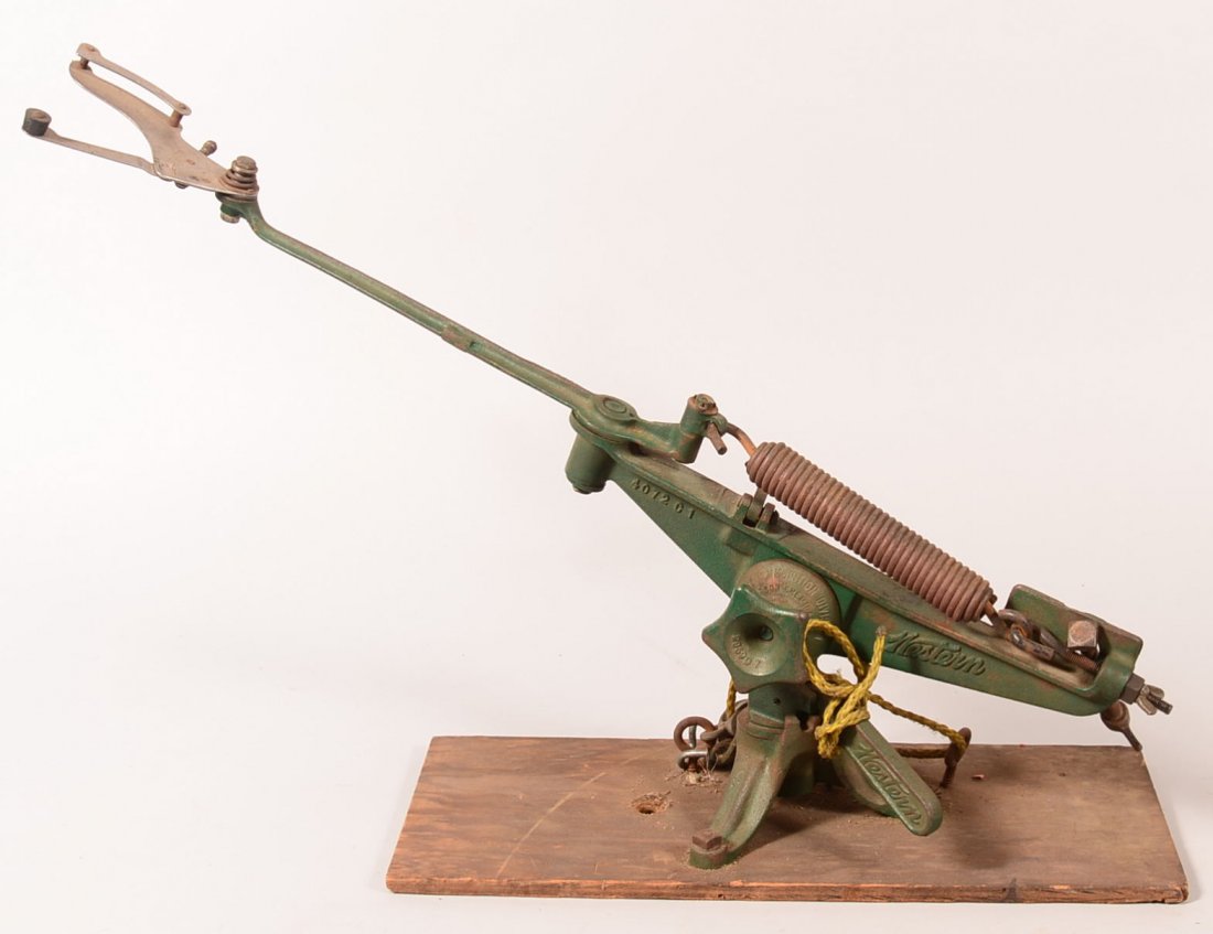 Vintage cast iron ground mounted clay bird thrower made: Vintage cast iron ground mounted clay bird thrower made by Western measuring 35" o/a and marked on the elevation pivot ARMS AND AMMUNITION DIVISION, EAST ALTON, ILL. Condition: good with most of the o
