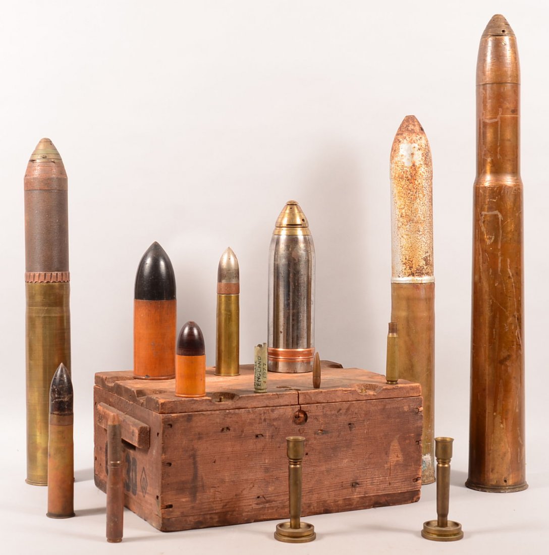 Ordnance lot including a large wood 30 caliber ammo box: Ordnance lot including a large wood 30 caliber ammo box dated 1903, (2) 37mm Hotchkiss rounds, (3) 75mm/3" rounds (one exercise), a 75mm/3" HE projectile, (2) wood display models, and a pair of trench