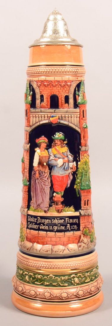 Large Simon Peter Gerz Earthenware Stein with courting: Large Simon Peter Gerz Earthenware Stein with courting couple scene and castle background. Pewter lid, intertwine branch handle, ink stamped mark and impressed with a 4L. 21-1/2"h. Condition: Very goo