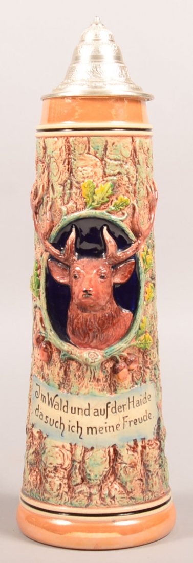 Large Simon Peter Gerz Earthenware Stein with Ten Point: Large Simon Peter Gerz Earthenware Stein with Ten Point Stag Plaque and tree form background, pewter lid, intertwine branch handle, ink stamped mark and impressed with a 2L., 17-1/2"h. Condition: Very
