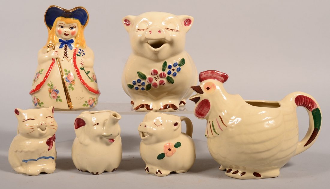 Six Various Shawnee Pottery Ceramic Pitchers. Bo Peep,: Six Various Shawnee Pottery Ceramic Pitchers. Bo Peep, 8-1/4"h., Smiley Pig, 7-3/4"h., Charlicleer pitcher, 7-1/2"h., Elephant creamer, 4-1/2"h., Puss-N-Boots creamer, 4-3/4"h. and Smiley Pig creamer,