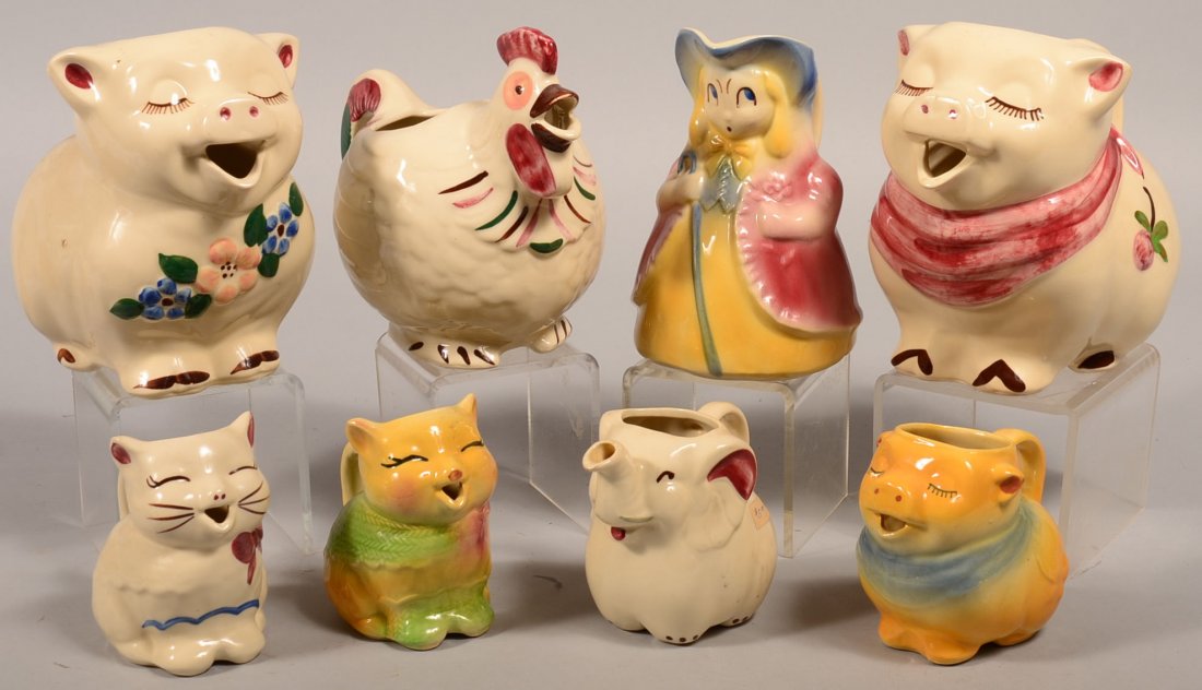 Eight Various Shawnee Pottery Ceramic Pitchers and: Eight Various Shawnee Pottery Ceramic Pitchers and Creamers. Bo Peep pitcher, Charlicleer chicken pitcher, two various Smiley Pig pitchers and a creamer, Elephant creamer and two various Puss-N-Boots 