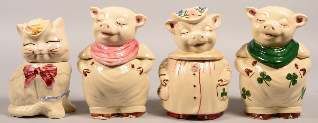 Four Shawnee Pottery Ceramic Cookie Jars. Two various: Four Shawnee Pottery Ceramic Cookie Jars. Two various color Smiley Pig, 11"h., Winnie the Pig, 11-1/2"h. and Puss-N-Boots, 10-1/4"h. Condition: Good, one Smiley hairlines on base and Winnie has a chip