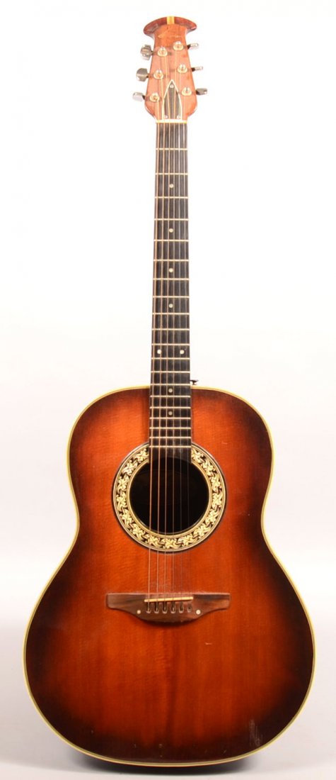 1970's Ovation Acoustic Six String Guitar with hard: 1970's Ovation Acoustic Six String Guitar with hard shell case. model #1111-1, serial #010993, with oval label manufactured in New Hartford, Conn. U.S.A. Synthetic bowl back.41-1/4"h. Condition: Very