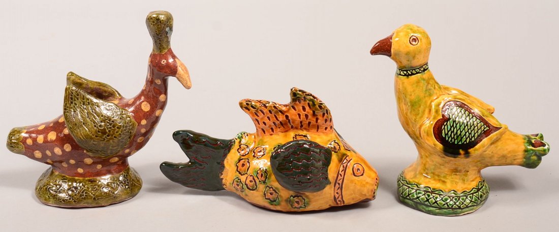 Three Folky Hand Molded and Glazed Redware Pottery: Three Folky Hand Molded and Glazed Redware Pottery Animal Whistles Signed "SC 1995". Two birds (one unsigned, but obviously the same maker), 6-3/4" and 7"h., and a fish, 8"l. Condition: Very good.