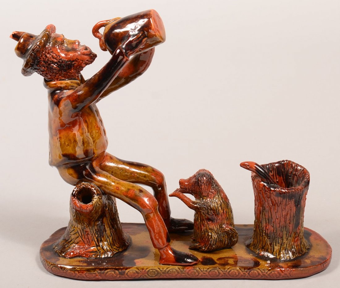 Breininger Redware Sculpture of Man Sitting on a Stump: Breininger Redware Sculpture of Man Sitting on a Stump with raised arms taking a drink from a jug, seated dog at his feet, and snake emerging from a hollow stump, all mounted on a slab base, tri-color