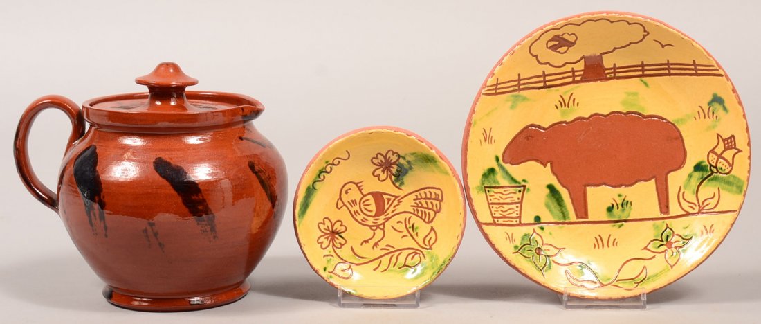 Three Pieces of Breininger Redware Pottery. Mottled: Three Pieces of Breininger Redware Pottery. Mottled glazed covered pitcher, signed and dated 1983, 5-1/2"h., and two small sgrafitto plates with bird and lamb, signed and dated 1999 and 2001, measurin