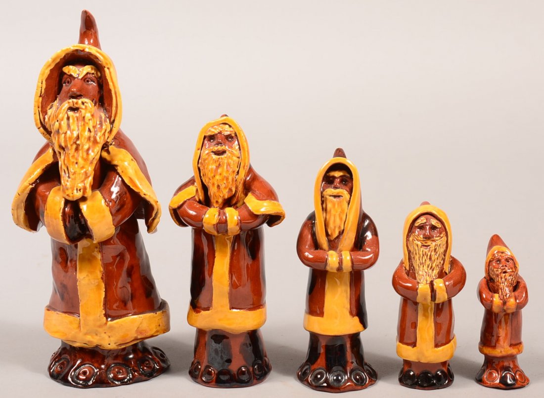 Five James J. Nyeste Redware Pottery graduated Santa: Five James J. Nyeste Redware Pottery graduated Santa Figures. Mottled glaze with yellow trim, all are signed and dated, 3-3/8" to 9"h. Condition: Very good.