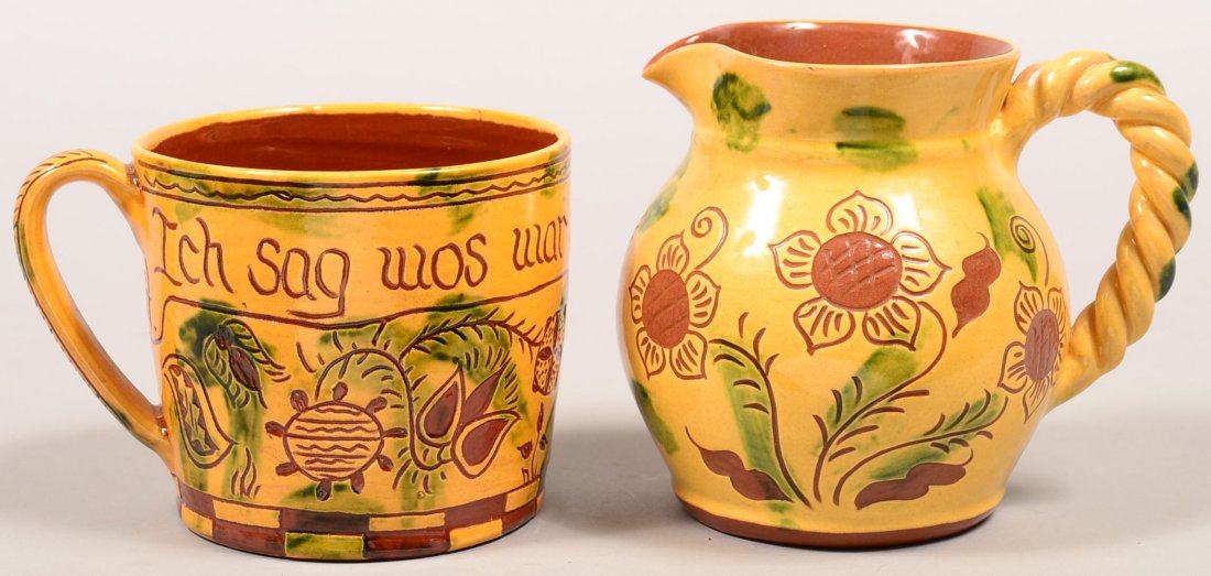 Two Breininger Redware Pottery Sgrafitto Decorated: Two Breininger Redware Pottery Sgrafitto Decorated Vessels. Both yellow ground with green mottled glaze. First is a German proverb mug translated to "I say what is true and drink what is clear", dated