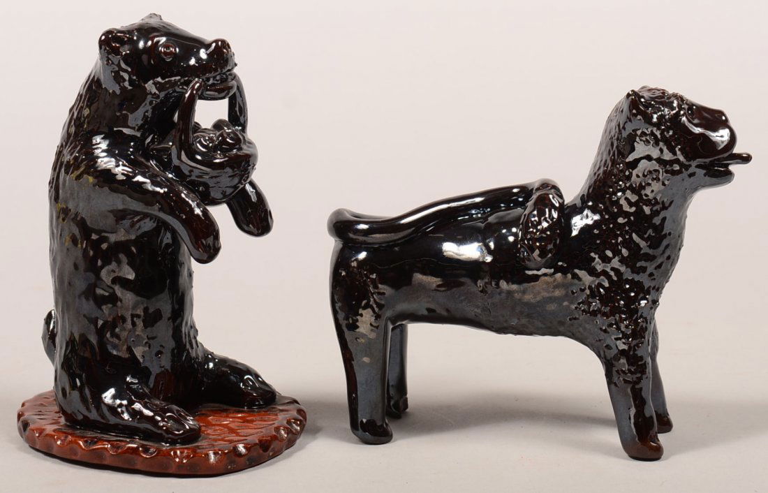 Two Breininger Manganese Glazed Redware Pottery Animal: Two Breininger Manganese Glazed Redware Pottery Animal Figures. Bear standing on his hind legs with a basket of apples in his mouth, dated 1989, 6-1/4"h. and a standing lion sticking his tongue out of