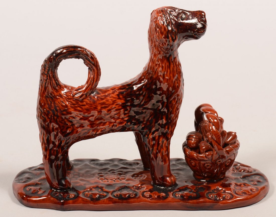 Large James J. Nyeste Hand Molded Redware Pottery Dog: Large James J. Nyeste Hand Molded Redware Pottery Dog with Lunch Basket Figure. Signed under the oval slab base "James J. Nyeste, Feb. 14, 1984", 10-1/4"l. Condition: Very good.