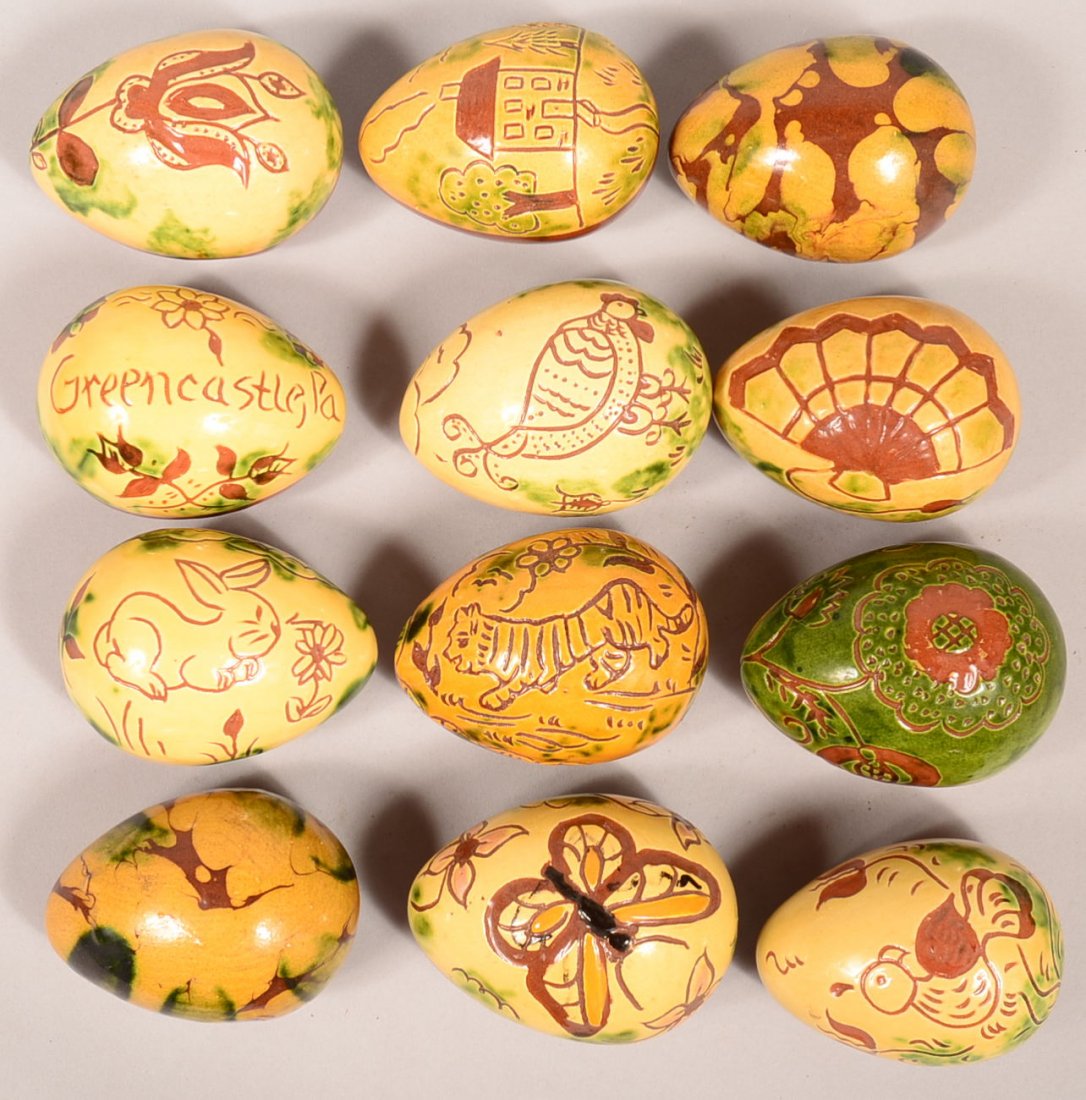 Lot of 12 Large Breininger Redware Pottery Eggs. Having: Lot of 12 Large Breininger Redware Pottery Eggs. Having various glazes and/or sgrafitto decoration. 3" to 3-1/2" long. Condition: Very good.