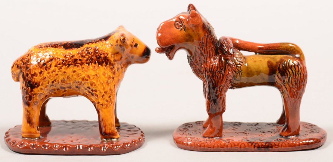 Two Breininger Hand Molded and Glazed Redware Pottery: Two Breininger Hand Molded and Glazed Redware Pottery Animal Figures. Sheep on an oval slab base, dated 1990, 5"l.. and a lion on an oval slab base sticking his tongue out of his mouth, dated 1984, 5-