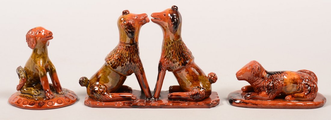 Three Various Breininger Hand Molded and Glazed Redware: Three Various Breininger Hand Molded and Glazed Redware Pottery Dog Figures. 1st: Two poodles facing each other, one with stick in mouth, dated 1987 (small firering line in base), 7-3/4"l. 2nd: Seated