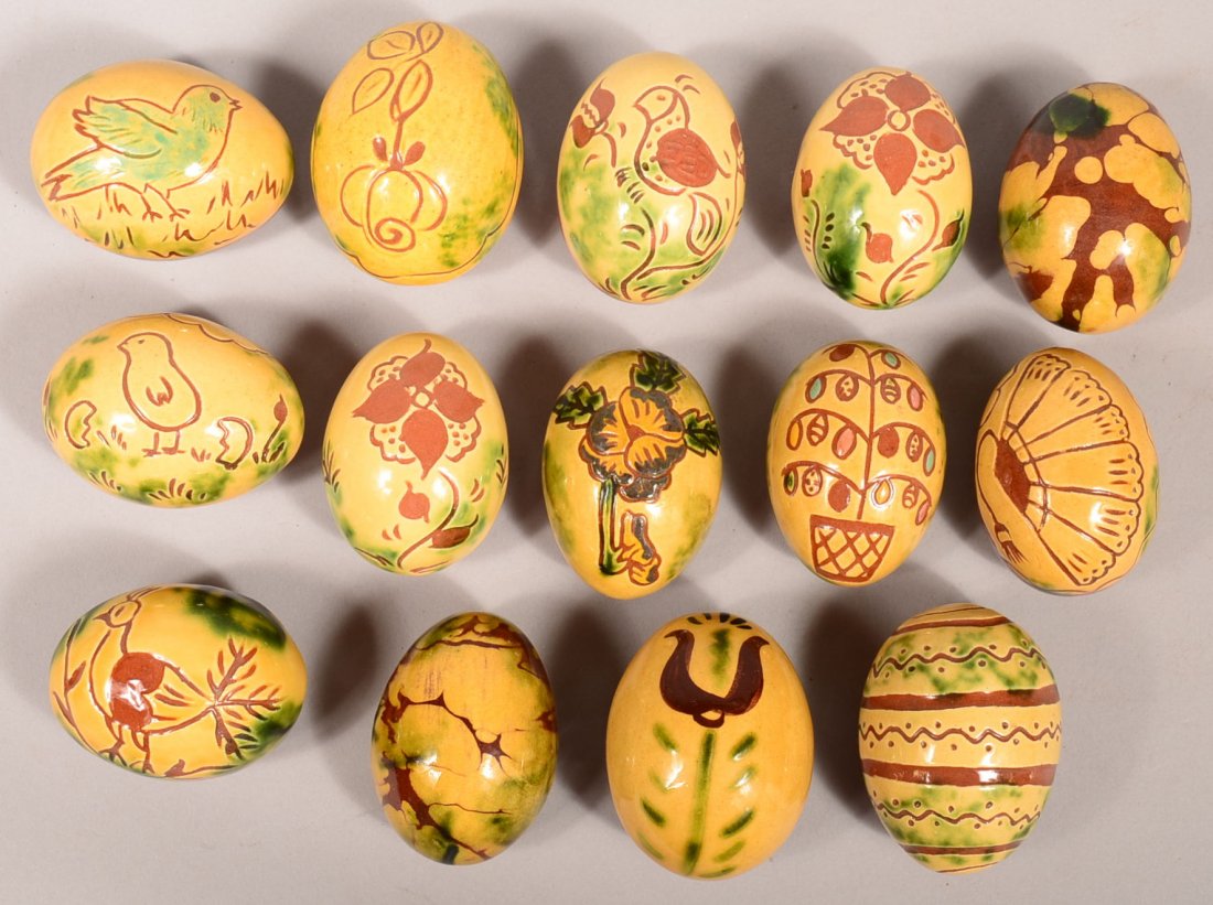Lot of 14 Breininger Redware Pottery eggs. Having: Lot of 14 Breininger Redware Pottery eggs. Having various glazes and/or sgrafitto decoration. 2-1/4" to 2-1/2"l. Condition: Very good.