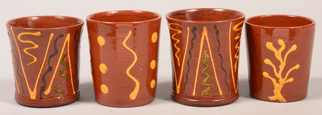 Four Various Breininger Redware Pottery Slip Decorated: Four Various Breininger Redware Pottery Slip Decorated Tumblers. All are signed and dated. 3-1/2" to 4"h. Condition: Very good.