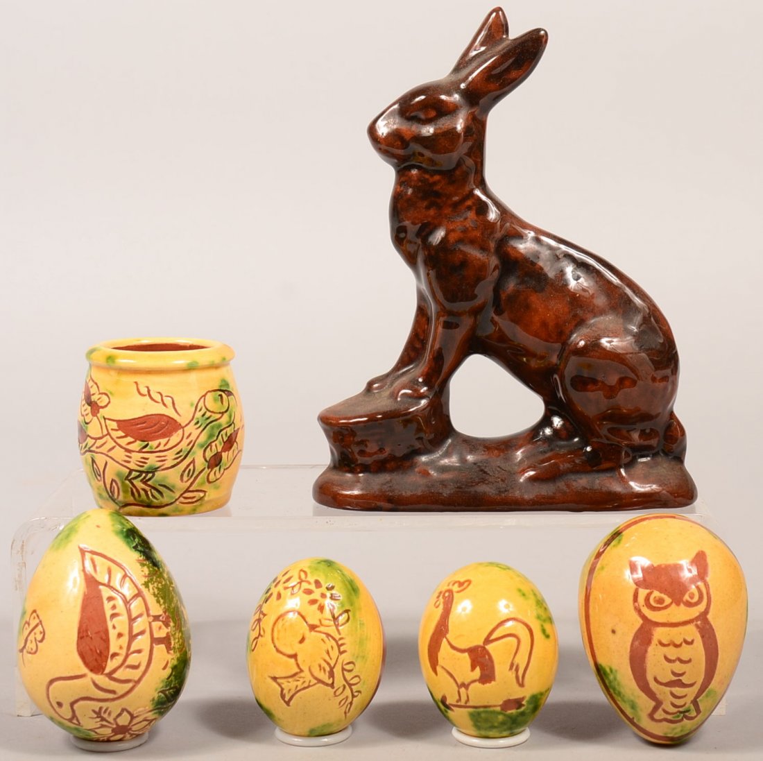 Five Easter Related Pieces of Breininger Redware: Five Easter Related Pieces of Breininger Redware Pottery and a miniature sgrafitto decorated crock. Four sgrafitto decorated eggs, 2-1/2" to 3-1/2"l., molded Easter bunny, 7-1/2"h. and a bird and foli