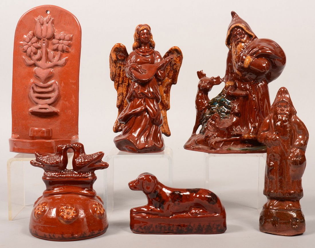 Six Various Pieces of Foltz Molded Redware Pottery. Two: Six Various Pieces of Foltz Molded Redware Pottery. Two Santa figures, 8-3/4" and 9"h., Angel, 8-1/2"h., candle sconce with embossed potted tulips, 9-3/4"h., love birds on dome, 5-3/4"h., and a reclin