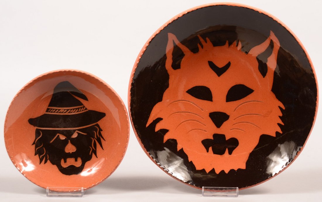 Two Breininger Redware Pottery Black and Orange Glazed: Two Breininger Redware Pottery Black and Orange Glazed Halloween Plates. Cat Face plate dated 1995, 10-1/2" diam. And Witch face plate dated 1996, 6-3/4" diam. Condition: Very good.