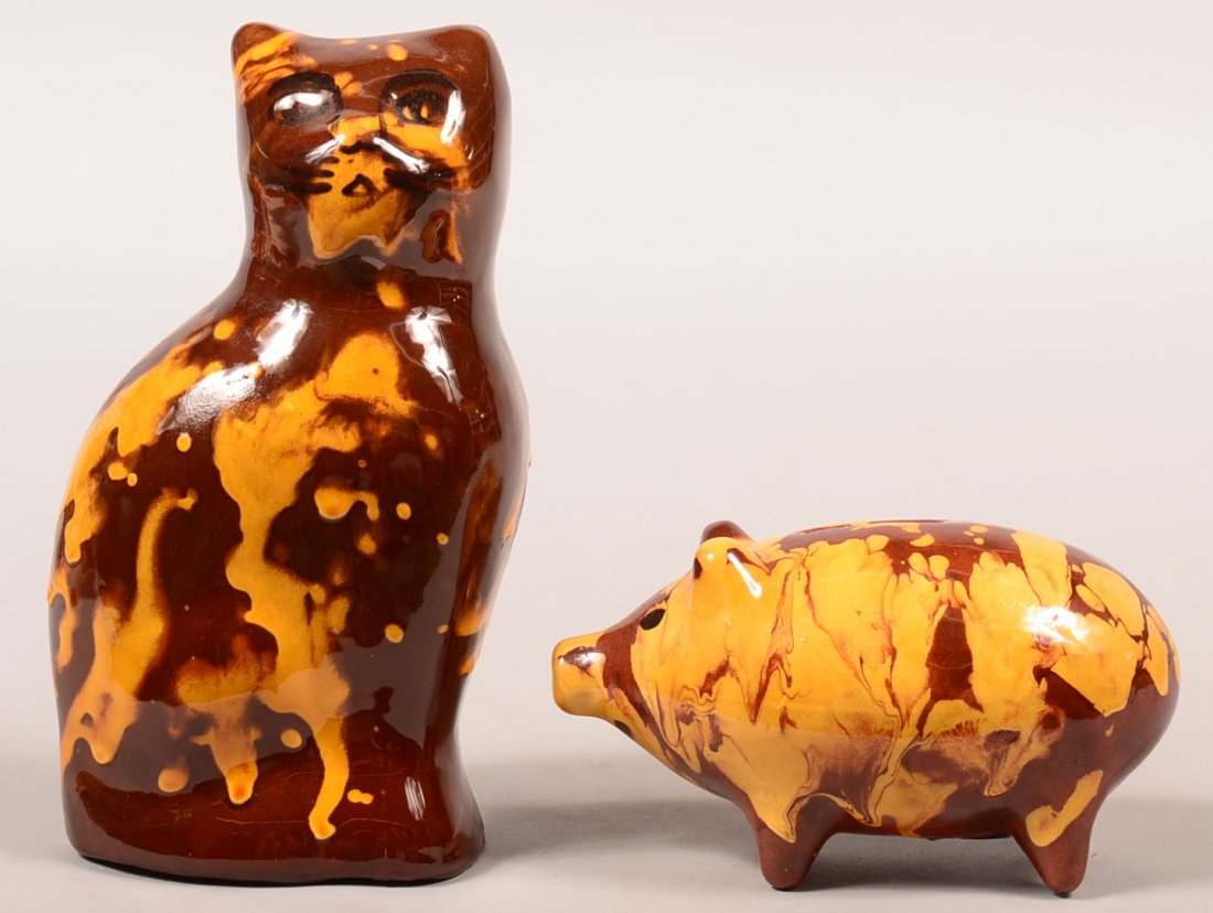 Two Pieces of Breininger Redware Mottled Glazed: Two Pieces of Breininger Redware Mottled Glazed Pottery. 1st: Pig form still bank dated 1982, 5-3/4"l. 2nd: molded seated cat dated 1983, 7-3/4"h. Condition: Very good.