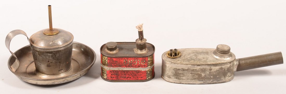 Three Tin Oil Lamps. First is a, Stillman's Safety: Three Tin Oil Lamps. First is a, Stillman's Safety with patent date of 1902 marked on handle, 5-1/2"h. x 7"dia. Second is a Primitive tin lamp made of sardine cans, 4"h. x 4-1/4"l. third is a Baker's 