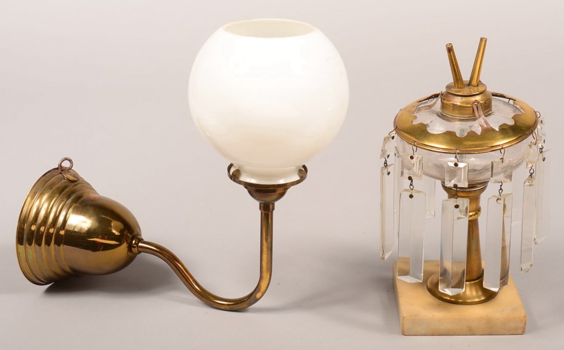 Two Brass Oil Lamps. Brass wall mounted lamp with milk: Two Brass Oil Lamps. Brass wall mounted lamp with milk glass ball shade, 9"h. Colorless glass font lamp having brass collar with camphene burner, brass cover with drop prisms and marble base, 8-1/2"h.