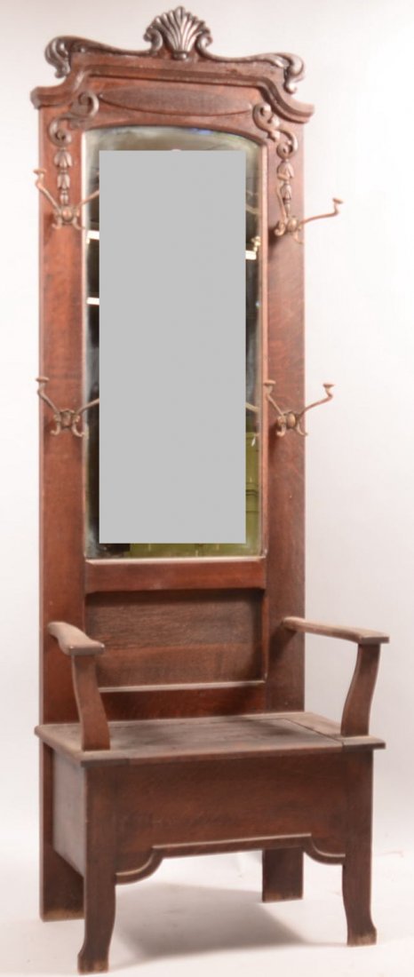 Quarter-sawn Oak Hall Bench with Applied carvings and: Quarter-sawn Oak Hall Bench with Applied carvings and bronzed cast iron Art Nuveau coat/hat racks. Mirror back with storage compartment under hinged seat. 83"h x 28-1/2"w x 17"d. Condition: Good with