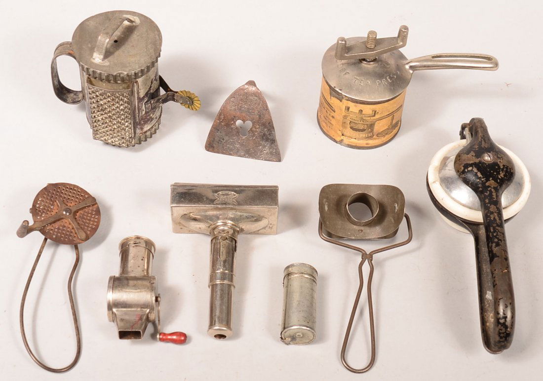 Grouping of Kitchenware. Including wrought iron dough: Grouping of Kitchenware. Including wrought iron dough scraper, nutmeg graters, beef-tea press, donut cutter, cookie cutter /grater gadget, Ergos adjustable brick ice cream mold, lemon press, Condition