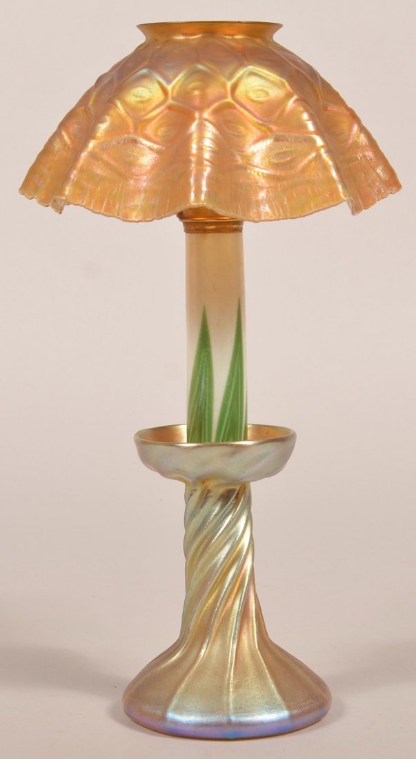 Tiffany Studios, New York Favrile Art Glass Candlestick: Tiffany Studios, New York Favrile Art Glass Candlestick Lamp. Gold iridescent honeycomb fluted glass shade, green on white feather decorated spring loaded candle holder, and flared ribbed base with tw