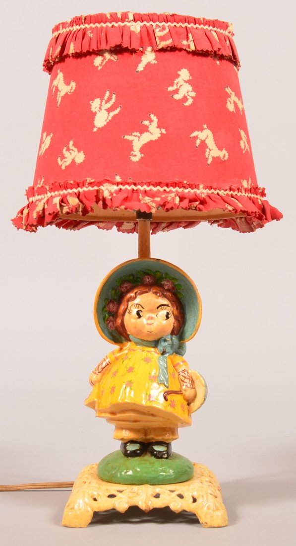 Hubley (Lancaster, PA) Cast Iron Dolly Dimple Table: Hubley (Lancaster, PA) Cast Iron Dolly Dimple Table Lamp. Unsigned Hubley #79, Grace Drayton design doorstop factory mounted into a lamp. Figure measures 7-3/4" high, with a period cloth lamb print sh