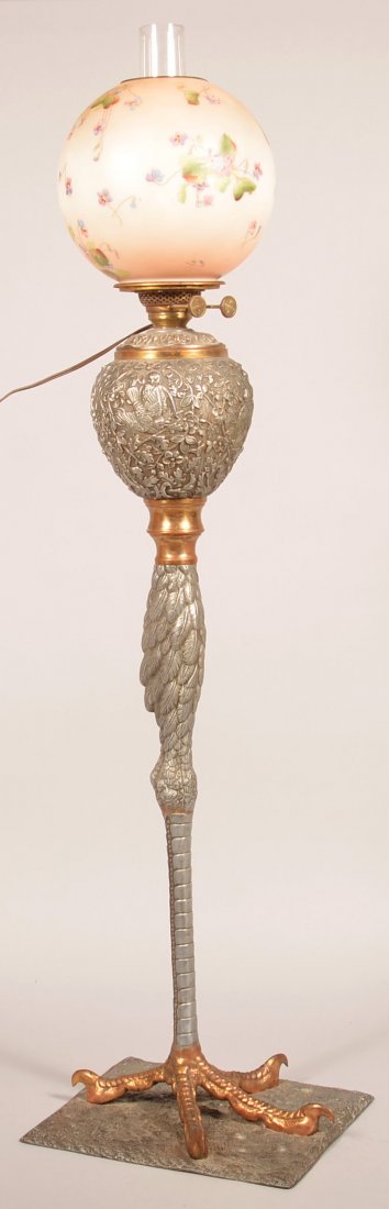 19th Century Spelter Metal Chicken Leg Piano Lamp.: 19th Century Spelter Metal Chicken Leg Piano Lamp. Embossed bird and foliate motif on font with chicken leg and talon base. Floral transfer decorated glass ball shade. Lamp has been electrified but di