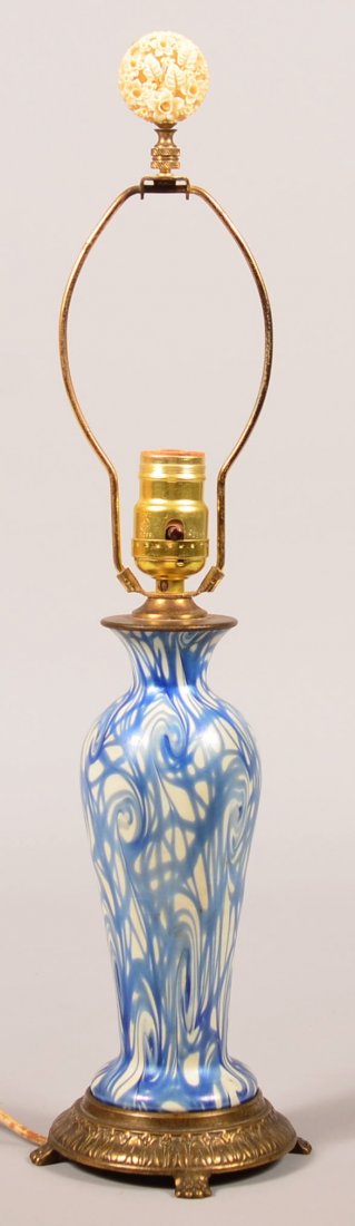 Unsigned Victor Durand Coil King Tut Lamp Base, C. 1925: Unsigned Victor Durand Coil King Tut Lamp Base, C. 1925. Irredescent blue on white glass mouted in a cast brass paw foot base. 21-3/4" high overall, vase form measures 9". Condition: Very good, missin